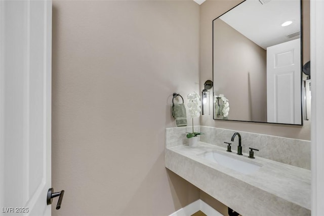 bathroom featuring visible vents and a sink