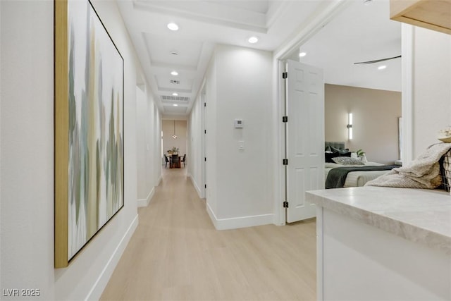 hallway featuring light wood-style floors, recessed lighting, baseboards, and visible vents