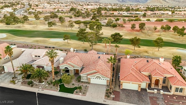 birds eye view of property featuring view of golf course, a mountain view, and a residential view