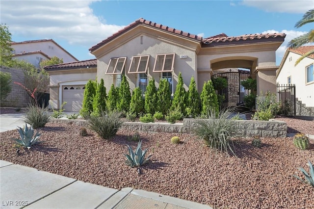 mediterranean / spanish home with stucco siding, a tile roof, and a garage