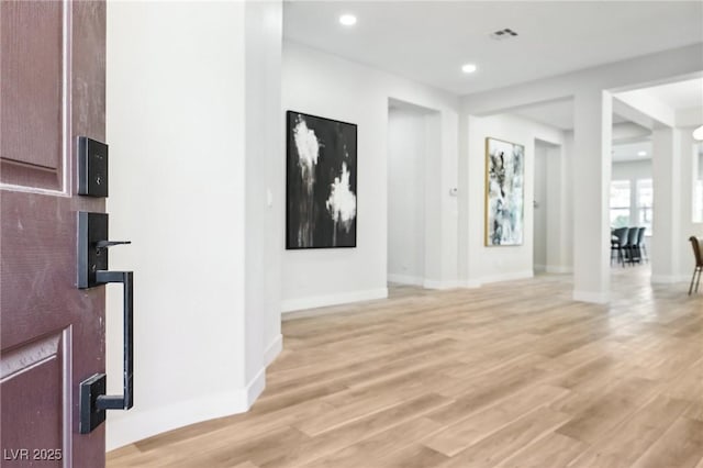 interior space featuring recessed lighting, baseboards, visible vents, and light wood-style floors
