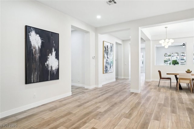 interior space with an inviting chandelier, light wood-style flooring, recessed lighting, baseboards, and visible vents