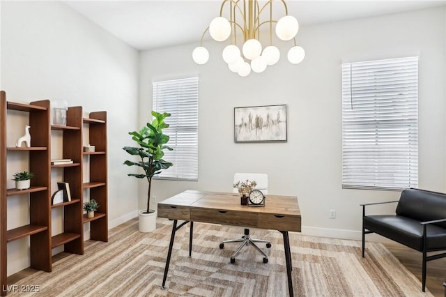 office featuring an inviting chandelier, baseboards, and light colored carpet