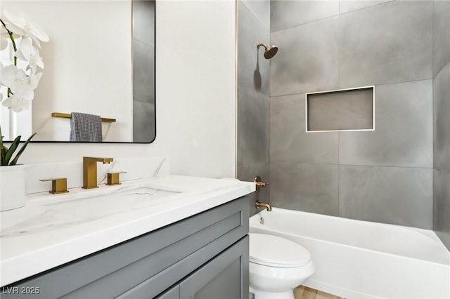 bathroom with vanity, toilet, and bathtub / shower combination