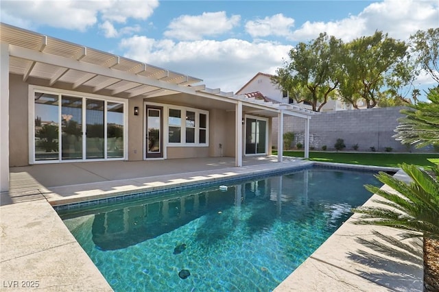 back of property with a pergola, stucco siding, a patio, and an outdoor pool
