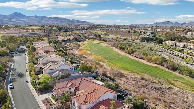aerial view with view of golf course, a mountain view, and a residential view