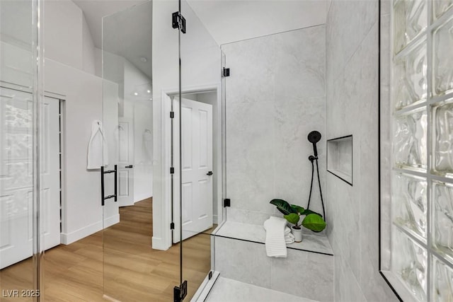 bathroom with walk in shower and wood finished floors