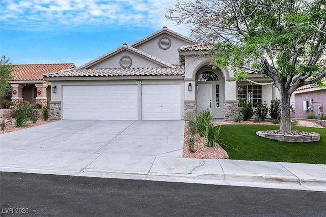 mediterranean / spanish house featuring stucco siding, a front lawn, stone siding, and a garage