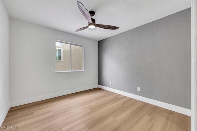 spare room with light wood-style floors, baseboards, and ceiling fan