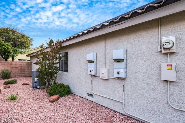 view of home's exterior featuring fence and stucco siding