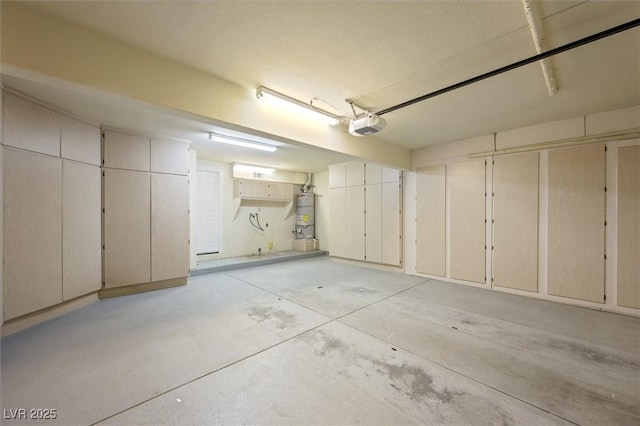 garage featuring strapped water heater and a garage door opener