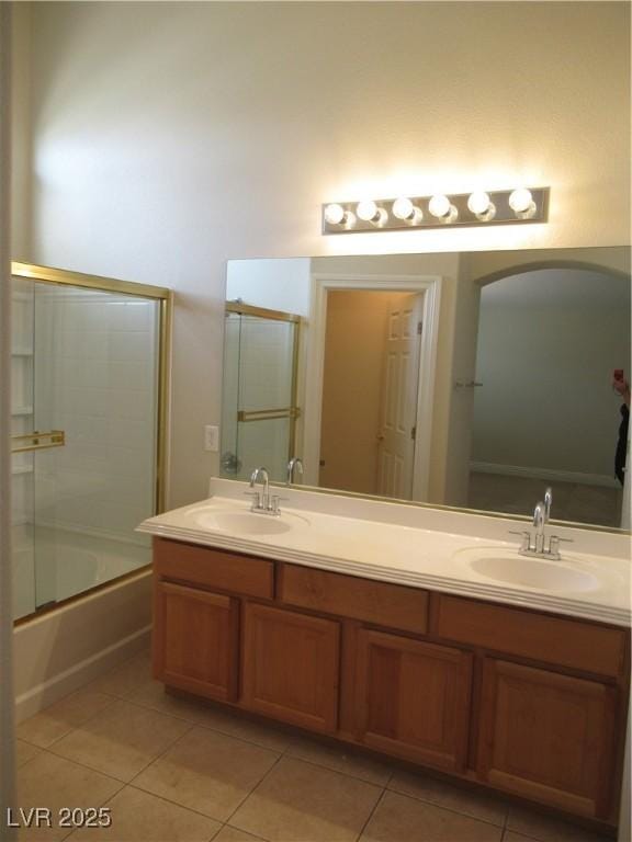 full bath featuring a sink, tile patterned flooring, and double vanity