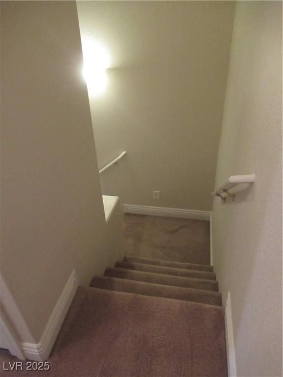stairs with carpet floors and baseboards