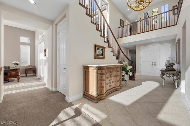 2933 Red Springs Dr, Las Vegas, NV 89135 - stairs with carpet flooring, a chandelier, a high ceiling, recessed lighting, and tile patterned floors