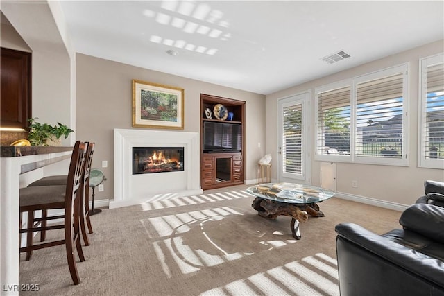 2933 Red Springs Dr, Las Vegas, NV 89135 - living room with a glass covered fireplace, light carpet, and built in shelves