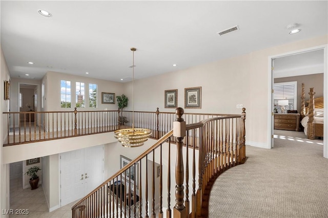 corridor featuring an upstairs landing, recessed lighting, baseboards, and carpet floors