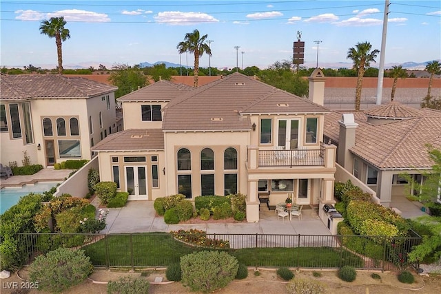 2933 Red Springs Dr, Las Vegas, NV 89135 - back of property featuring a balcony, french doors, a fenced backyard, stucco siding, and a patio area