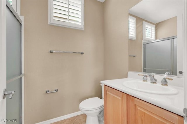 2318 Shorewood Hills Ave, Henderson, NV 89052 - bathroom with tile patterned flooring, a shower with shower door, vanity, toilet, and baseboards