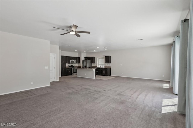 unfurnished living room with baseboards, a ceiling fan, carpet, and recessed lighting