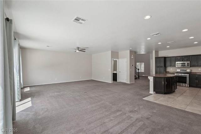 unfurnished living room with recessed lighting, baseboards, visible vents, and light carpet