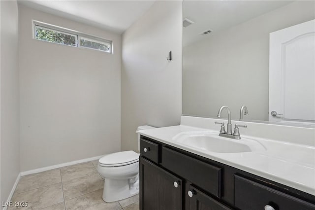 bathroom with vanity, toilet, tile patterned floors, baseboards, and visible vents
