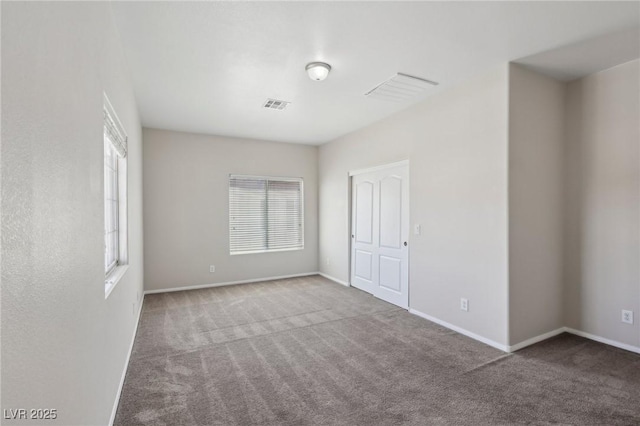 empty room featuring baseboards, carpet, and visible vents