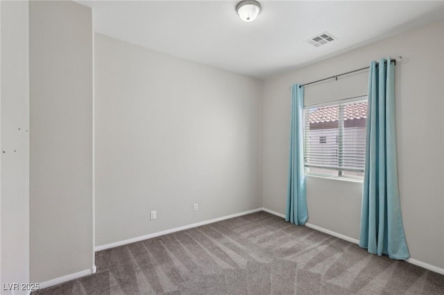 carpeted empty room featuring baseboards and visible vents