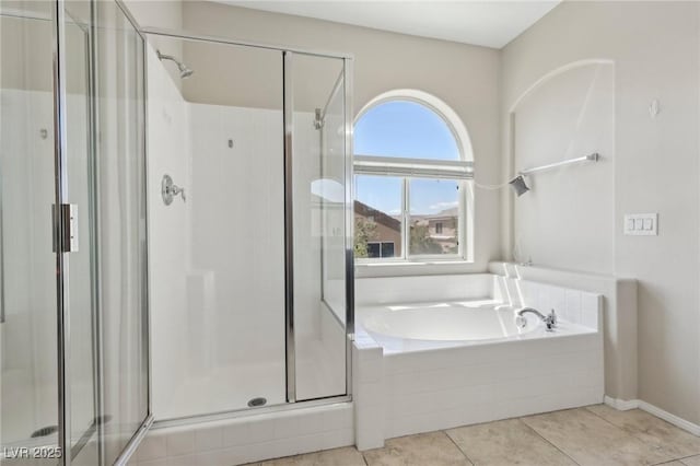 bathroom with tile patterned floors, a garden tub, and a stall shower