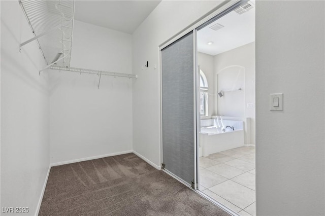 walk in closet with carpet floors and visible vents