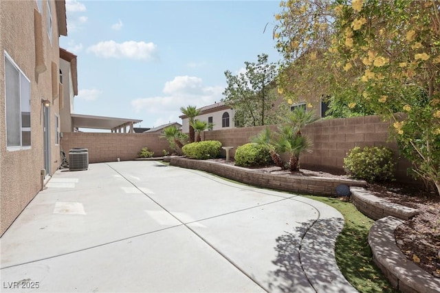 view of patio with central air condition unit and a fenced backyard