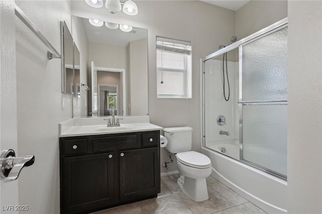 full bath featuring toilet, enclosed tub / shower combo, tile patterned flooring, and vanity