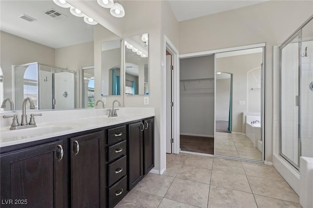 full bath with visible vents, a sink, a garden tub, and a stall shower
