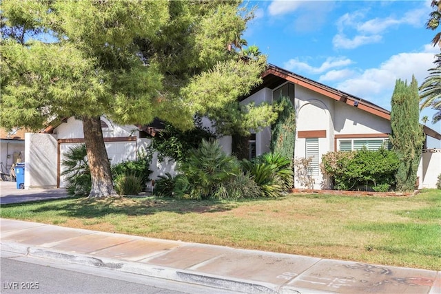 4680 Freshwater Dr, Las Vegas, NV 89103 - view of property hidden behind natural elements with stucco siding and a front yard