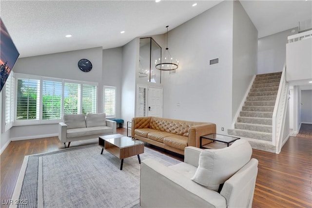 4680 Freshwater Dr, Las Vegas, NV 89103 - living room with visible vents, wood finished floors, high vaulted ceiling, baseboards, and stairs
