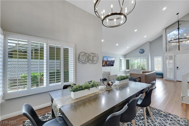 4680 Freshwater Dr, Las Vegas, NV 89103 - dining space with high vaulted ceiling, a chandelier, recessed lighting, baseboards, and dark wood-style floors