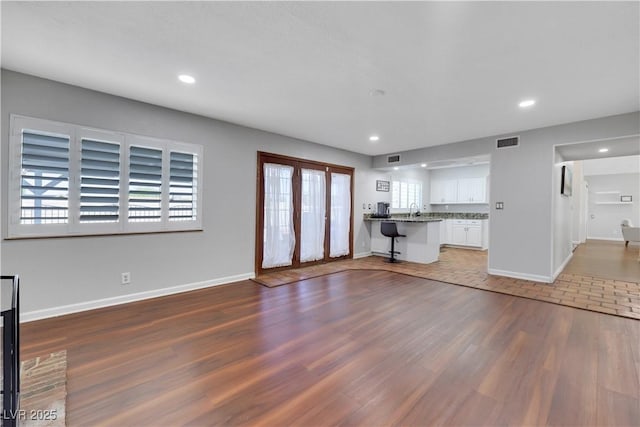 4680 Freshwater Dr, Las Vegas, NV 89103 - unfurnished living room featuring recessed lighting, baseboards, visible vents, and wood finished floors