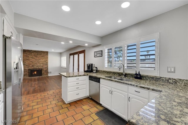 4680 Freshwater Dr, Las Vegas, NV 89103 - kitchen with a sink, white cabinets, stainless steel appliances, and a peninsula