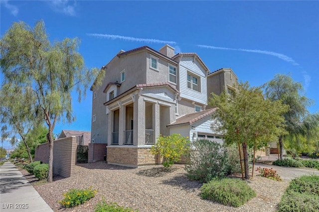 96 Campbelltown Ave, Henderson, NV 89015 - view of side of home with a garage, stucco siding, and stone siding