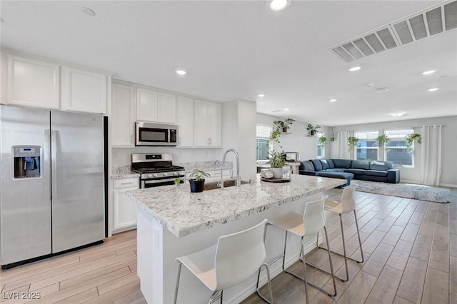 96 Campbelltown Ave, Henderson, NV 89015 - kitchen with plenty of natural light, a sink, light wood-style flooring, and stainless steel appliances
