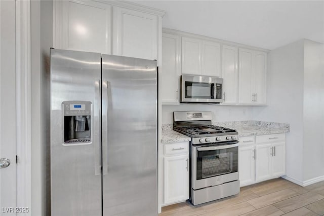 96 Campbelltown Ave, Henderson, NV 89015 - kitchen with light stone counters, stainless steel appliances, white cabinetry, and wood finish floors