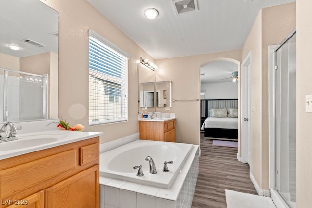 full bathroom with visible vents, a garden tub, ceiling fan, and a stall shower