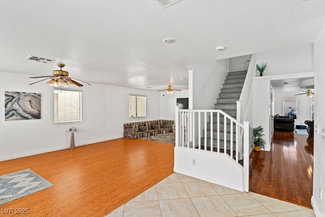 interior space featuring visible vents, baseboards, ceiling fan, and wood finished floors