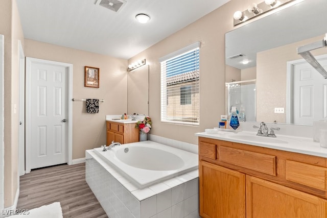 full bath featuring a sink, a stall shower, and visible vents