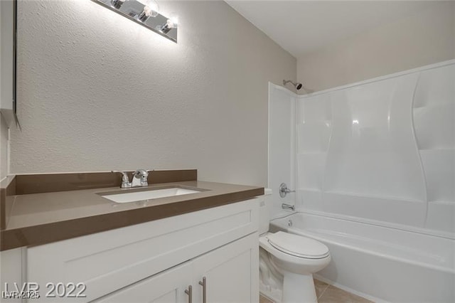 bathroom with a textured wall, tile patterned flooring, vanity, toilet, and shower / washtub combination