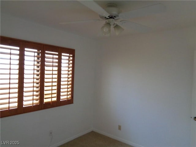 empty room featuring carpet flooring, ceiling fan, and baseboards