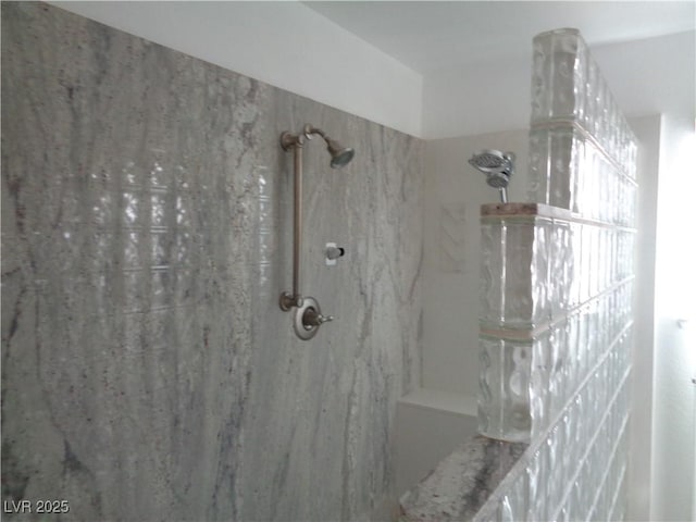 bathroom with a marble finish shower