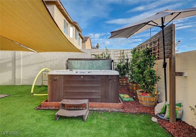 view of yard with a hot tub and fence