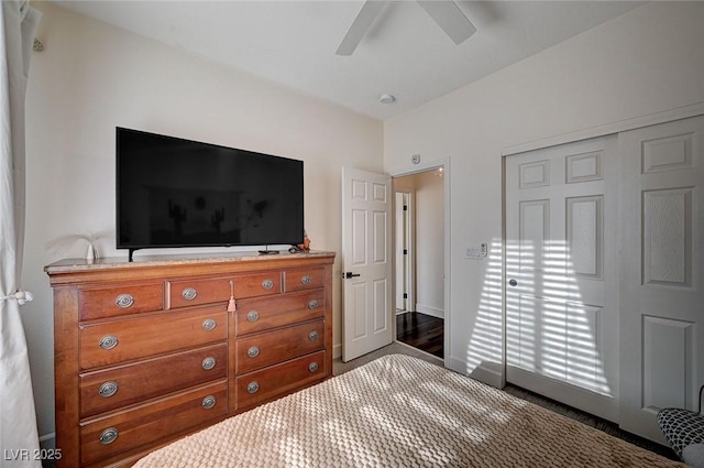 carpeted bedroom with ceiling fan, baseboards, and a closet