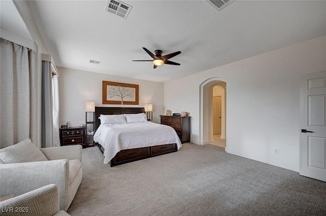 bedroom with visible vents, arched walkways, a ceiling fan, and carpet flooring