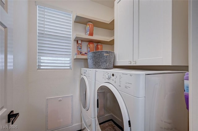 washroom with washing machine and dryer and cabinet space